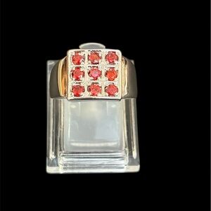 An elegant silver and red gemstone ring.